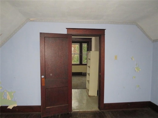 additional living space featuring dark hardwood / wood-style floors and vaulted ceiling