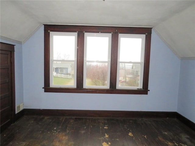 bonus room featuring lofted ceiling and dark wood-type flooring