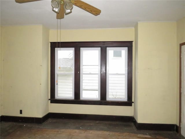 unfurnished room featuring ceiling fan and a healthy amount of sunlight