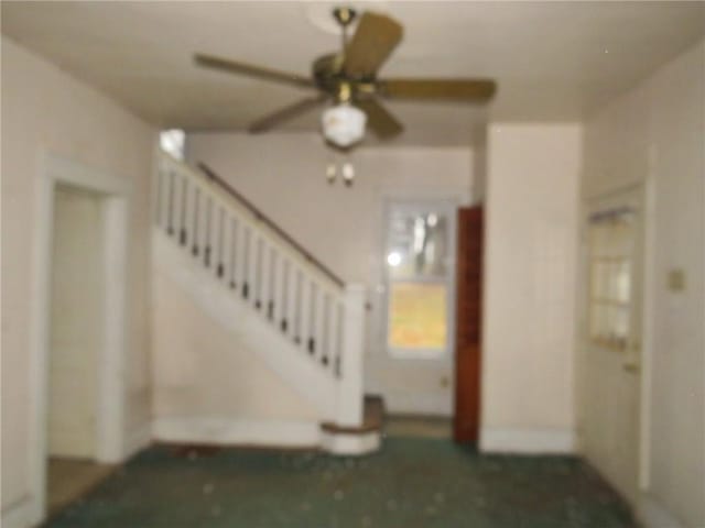 unfurnished living room with ceiling fan