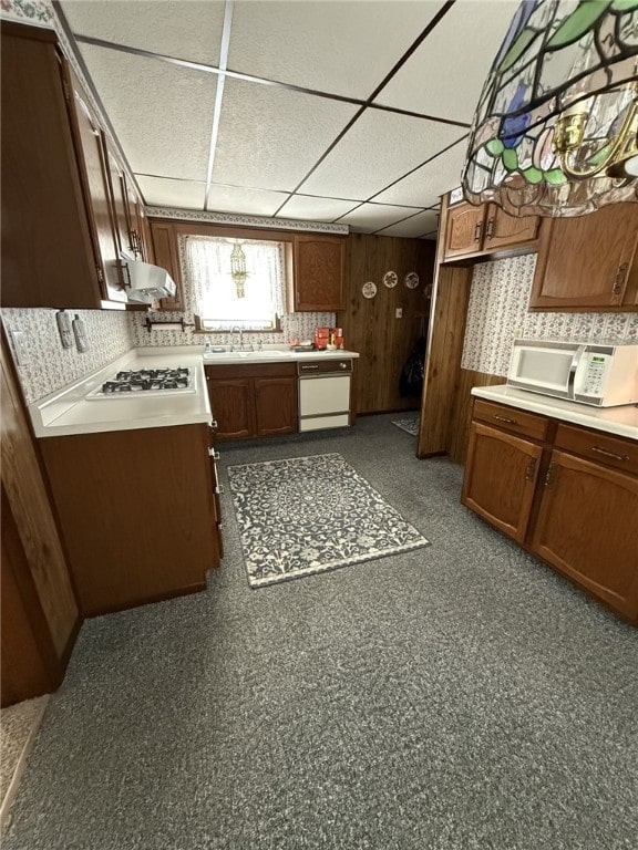 kitchen featuring a paneled ceiling, dishwasher, sink, and stainless steel gas stovetop