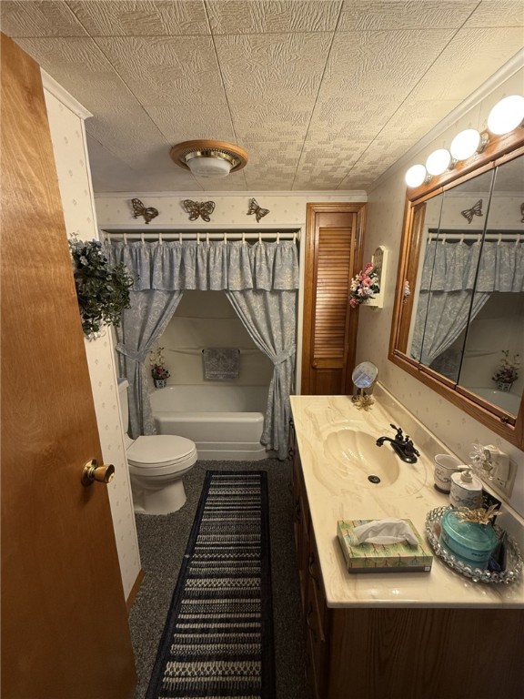 bathroom featuring vanity, toilet, and a tub to relax in