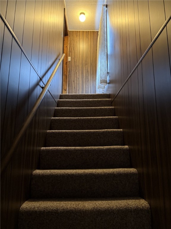 stairs with wood walls