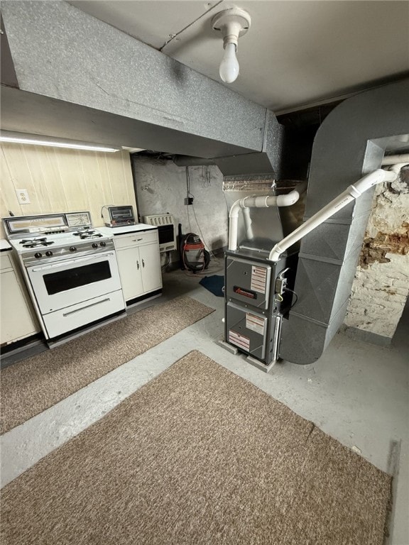 kitchen with white cabinets and white range with gas cooktop