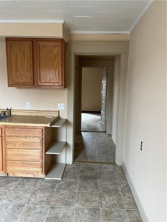 hallway with ornamental molding and sink