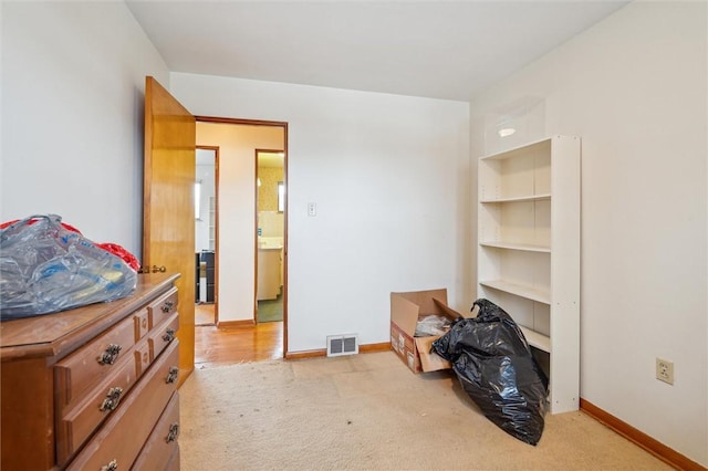 bedroom featuring light colored carpet