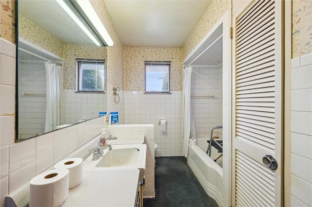 bathroom featuring vanity, tile walls, and shower / tub combo