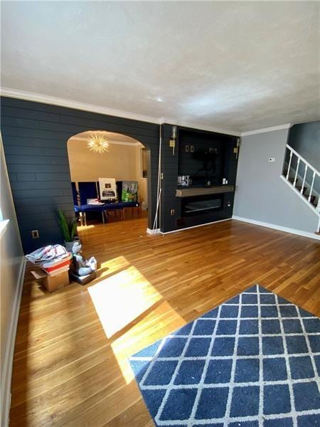 living room featuring hardwood / wood-style flooring and ornamental molding