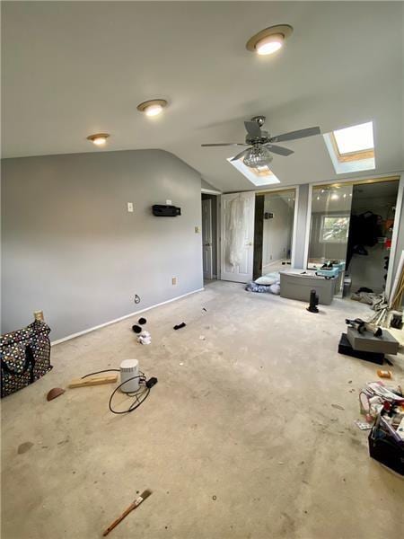 interior space featuring ceiling fan and lofted ceiling with skylight