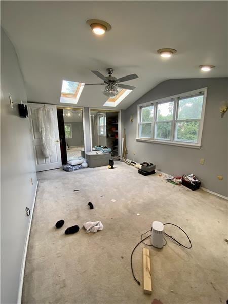 additional living space with ceiling fan and lofted ceiling with skylight