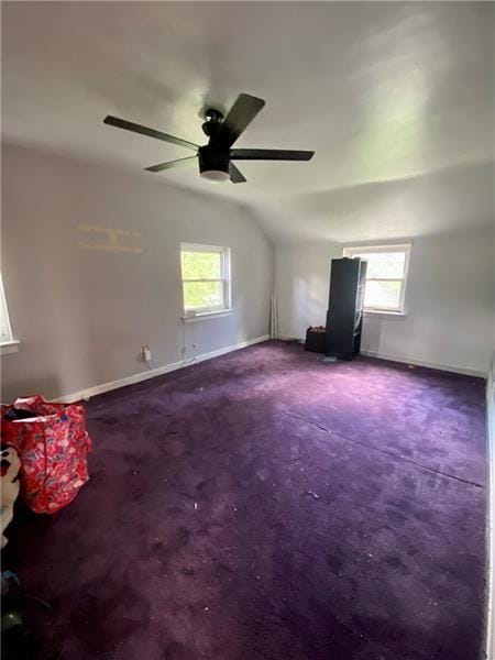 additional living space featuring carpet, ceiling fan, lofted ceiling, and a wealth of natural light