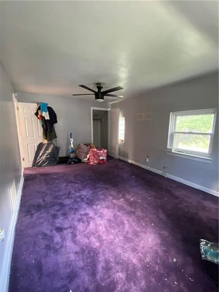 unfurnished bedroom featuring ceiling fan