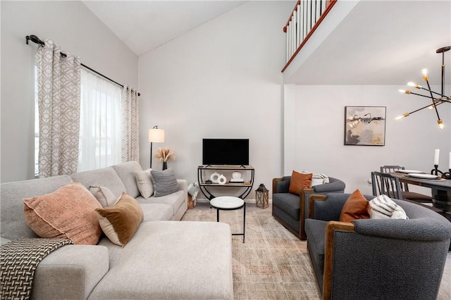 carpeted living room with an inviting chandelier and lofted ceiling