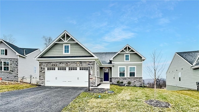 craftsman house with a front lawn and a garage