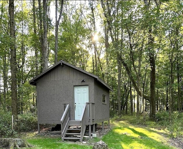 view of outbuilding featuring a yard