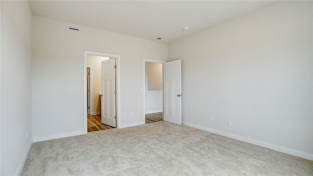 unfurnished bedroom featuring light carpet