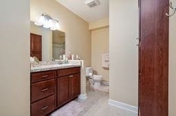 bathroom with vanity, toilet, and tile patterned flooring