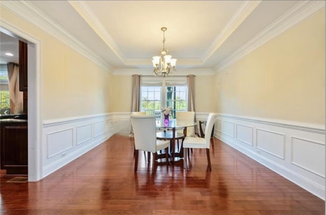 dining room featuring ornamental molding, dark hardwood / wood-style flooring, and a chandelier