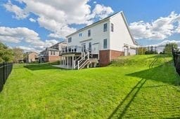 rear view of property featuring a lawn