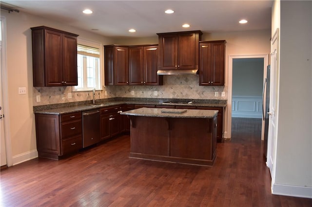 kitchen featuring black cooktop, a center island, dark stone countertops, stainless steel dishwasher, and decorative backsplash