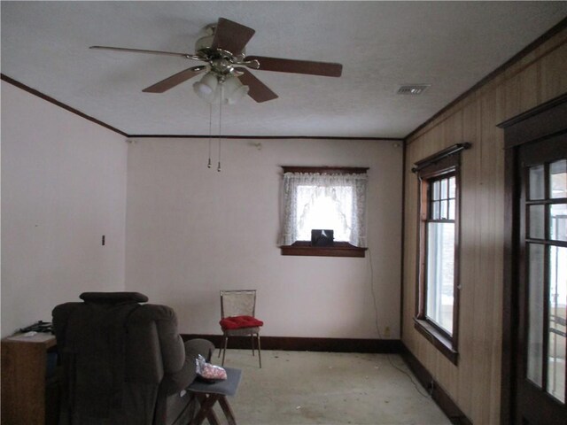 interior space with ceiling fan, light carpet, and ornamental molding