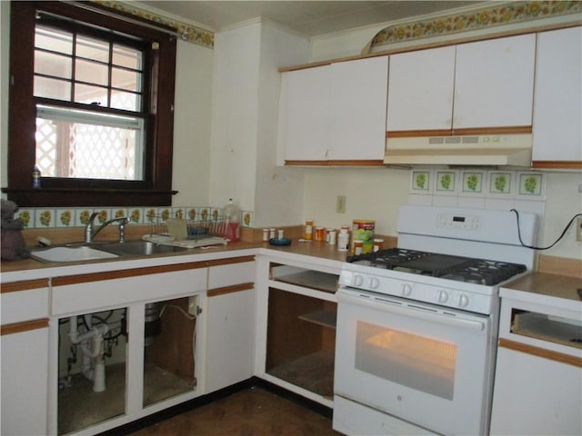 kitchen featuring tasteful backsplash, sink, white cabinets, and white range with gas stovetop