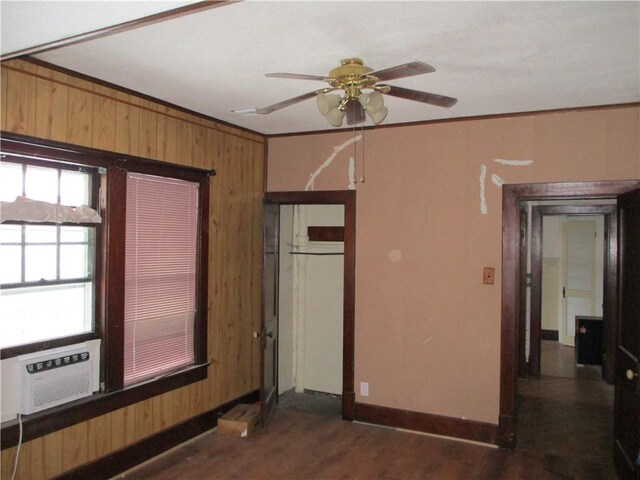 unfurnished bedroom with ceiling fan, dark hardwood / wood-style flooring, ornamental molding, and a closet