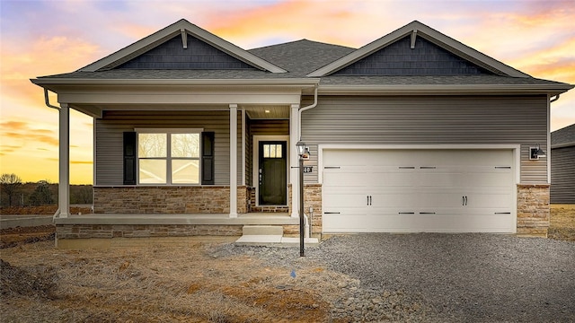 craftsman-style house featuring covered porch and a garage