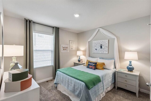 bedroom featuring light colored carpet and multiple windows