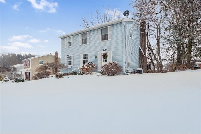 view of front of property featuring central AC and a chimney