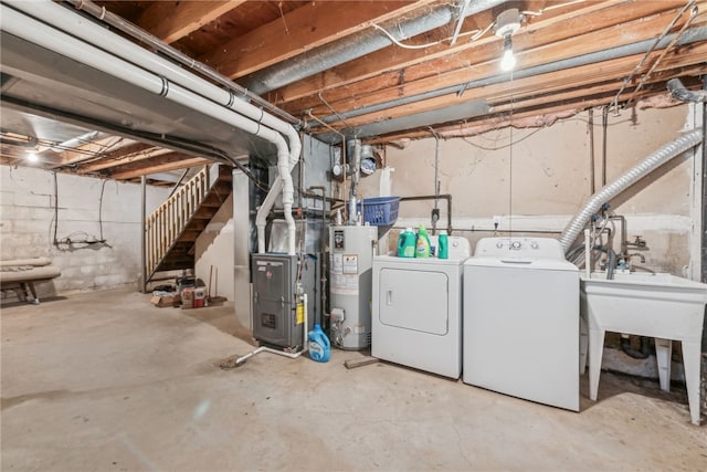 basement featuring washing machine and dryer, heating unit, and gas water heater