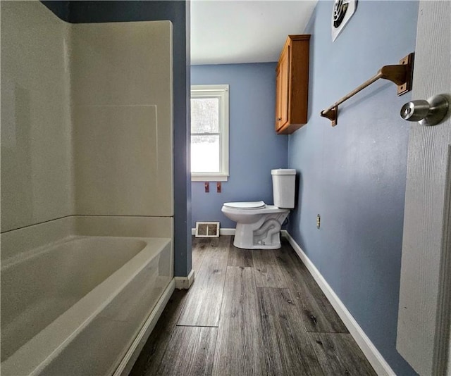 bathroom featuring hardwood / wood-style flooring and toilet