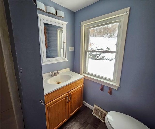 bathroom featuring hardwood / wood-style flooring, vanity, and toilet