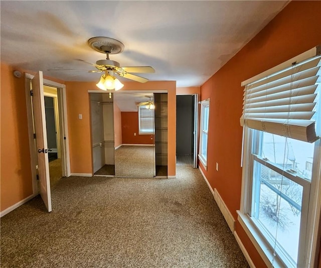 unfurnished room with ceiling fan and carpet floors