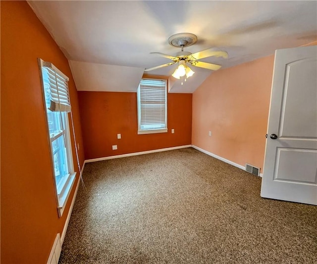 bonus room featuring carpet, visible vents, vaulted ceiling, and baseboards