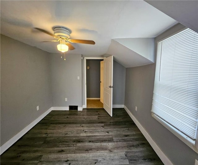 bonus room with dark hardwood / wood-style floors, vaulted ceiling, and ceiling fan