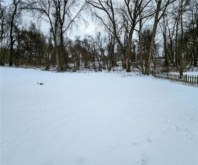 yard layered in snow with fence