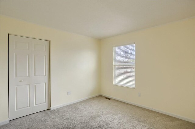 spare room with light carpet