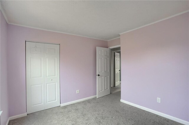 unfurnished bedroom featuring light carpet, a closet, and crown molding