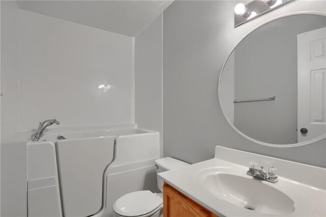 bathroom featuring vanity and toilet