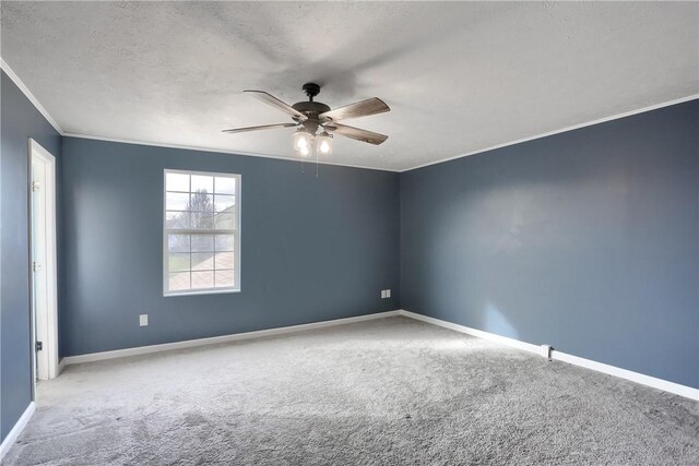 carpeted empty room with ceiling fan, ornamental molding, and a textured ceiling