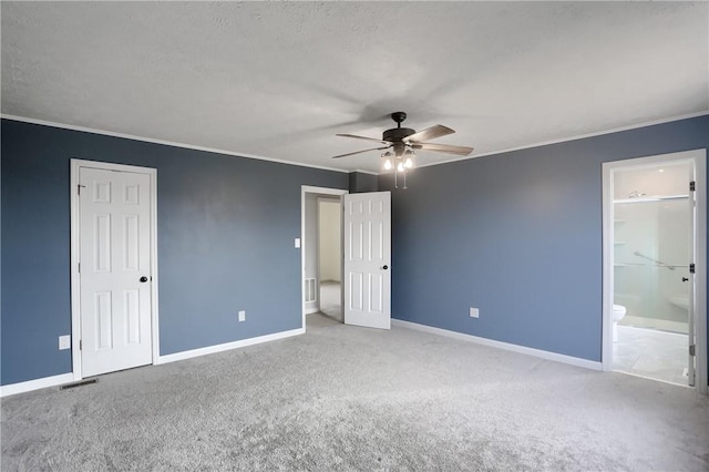 unfurnished bedroom featuring connected bathroom, ceiling fan, crown molding, and light colored carpet