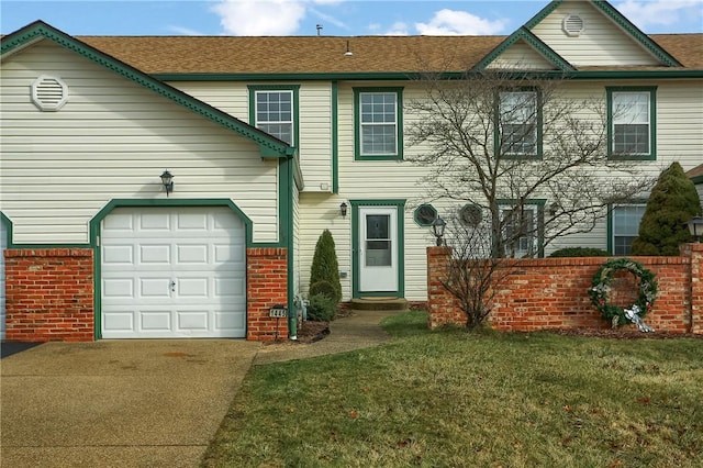 view of front of property featuring a garage and a front lawn