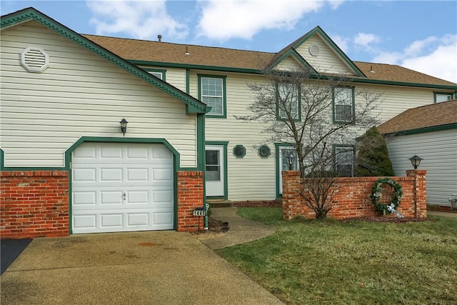 view of front of property featuring a front lawn and a garage