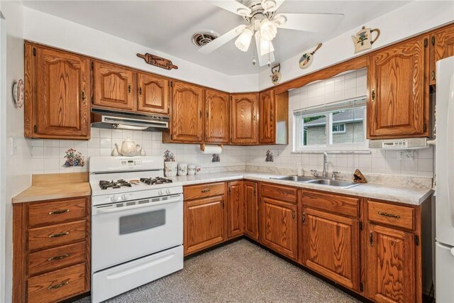 kitchen with white appliances, tasteful backsplash, ceiling fan, and sink