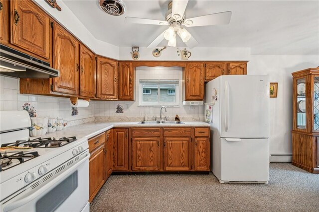 kitchen featuring white appliances, ventilation hood, ceiling fan, baseboard heating, and sink