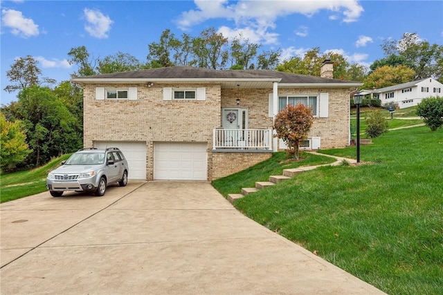 raised ranch featuring a garage and a front yard