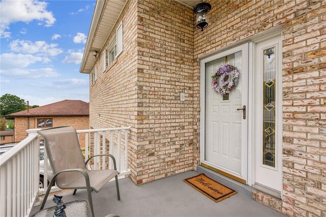 view of exterior entry with brick siding