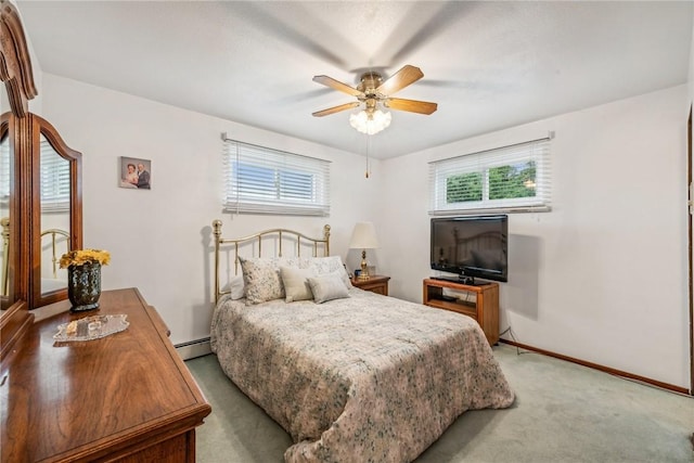 bedroom with ceiling fan, light colored carpet, and a baseboard radiator