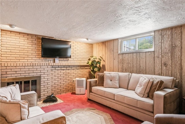 carpeted living room with wood walls and a textured ceiling